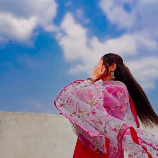 a woman in a kimono looking up into the sky