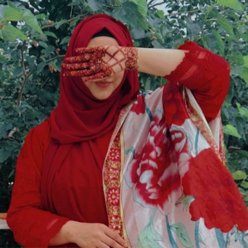 a woman in a red hijab is covering her face with her hands