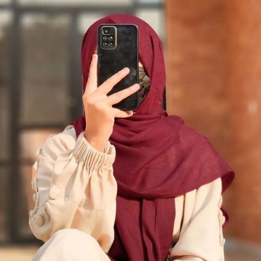 a woman in a red hijab is holding a cell phone