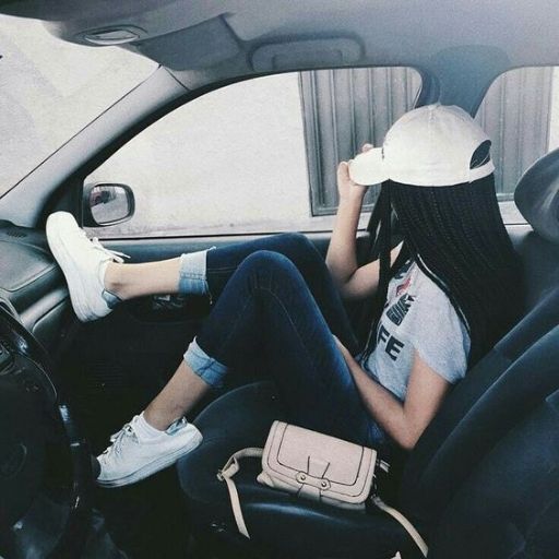 a woman sitting in the back seat of a car