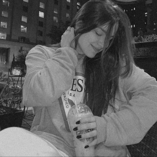 a woman sitting on a bench holding a bottle of alcohol