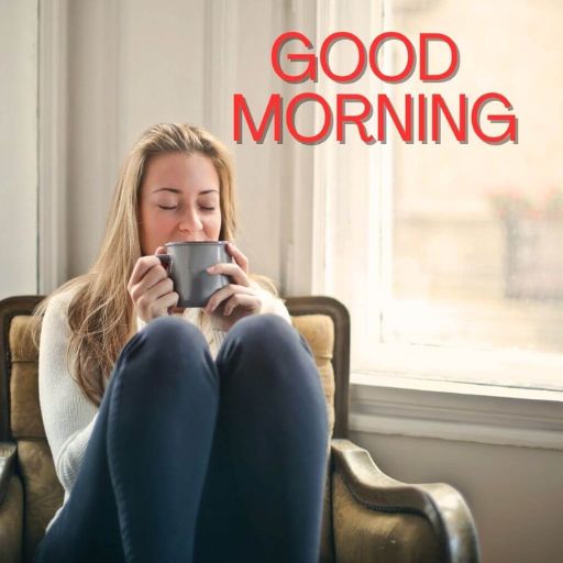 a woman sitting on a couch holding a cup of coffee