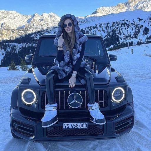 a woman sitting on the hood of a mercedes benz benz benz benz benz benz benz