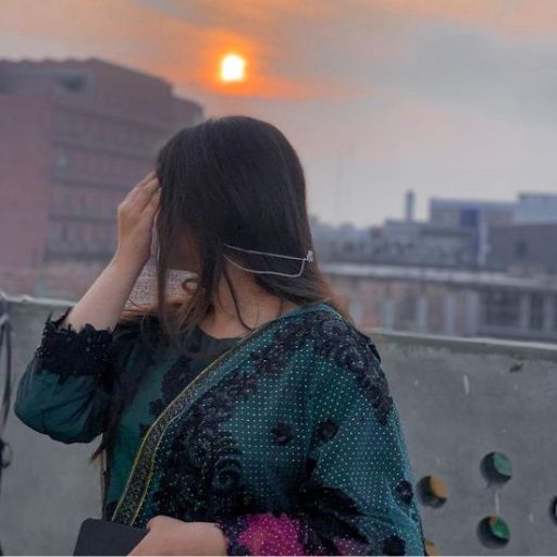 a woman talking on a cell phone while standing on top of a building