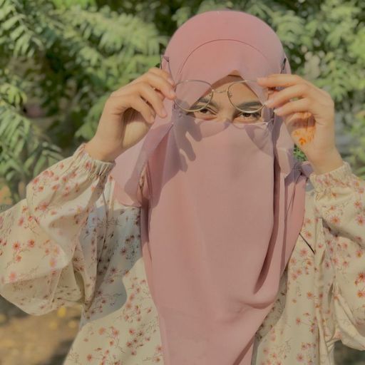 a woman wearing a pink hijab and glasses