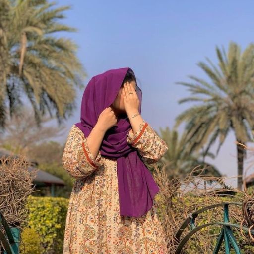 a woman wearing a purple scarf covering her face