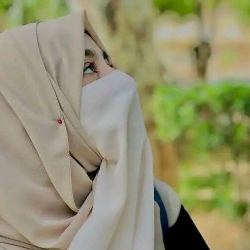 a woman wearing a white shawl looking up at the sky