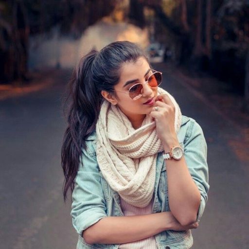 a woman wearing sunglasses and a scarf