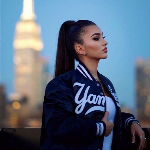 a woman with a ponytail standing in front of a city skyline