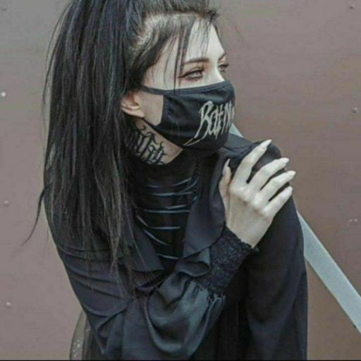 a woman with black hair wearing a black mask