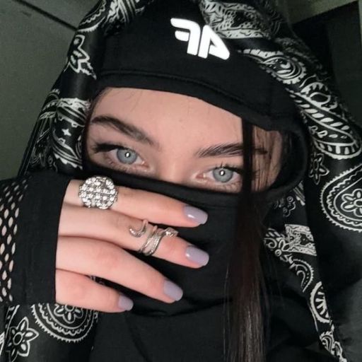 a woman with blue eyes wearing a bandana