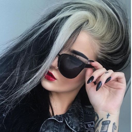 a woman with grey hair and black sunglasses