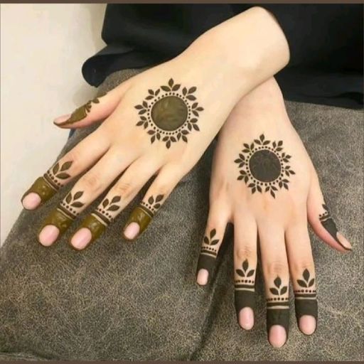 a woman with henna tattoos on her hands