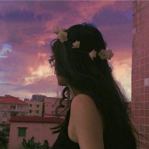 a woman with long black hair and flowers in her hair