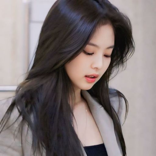 a woman with long black hair is looking down