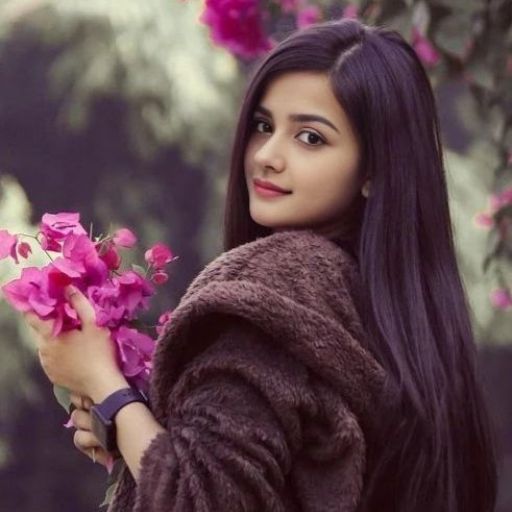 a woman with long hair holding a bunch of flowers