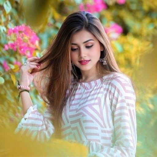 a woman with long hair standing in front of flowers