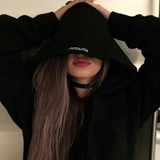 a woman with long hair wearing a black hoodie