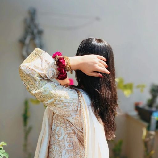 a woman with long hair wearing a white dress