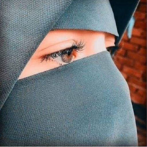 a woman's eye is seen through a veil