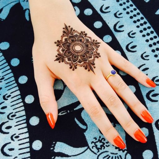 a woman's hand with a henna tattoo on it