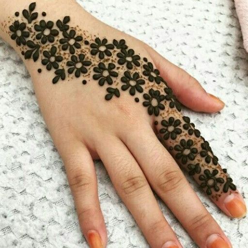 a woman's hand with black flowers on it