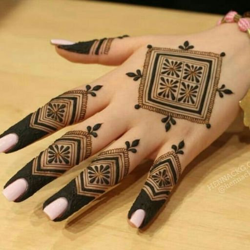 a woman's hand with henna tattoos on it