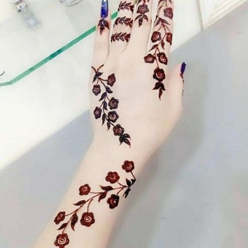 a woman's hands with henna tattoos on them (2)