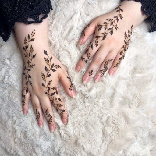 a woman's hands with henna tattoos on them (3)