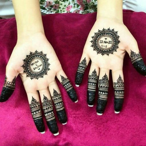 a woman's hands with henna tattoos on them (4)