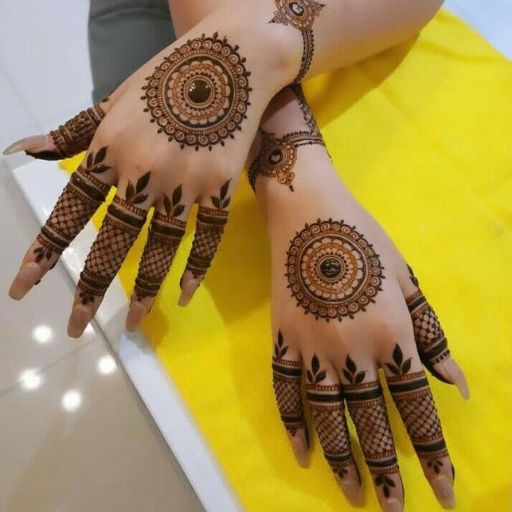 a woman's hands with henna tattoos on them (5)