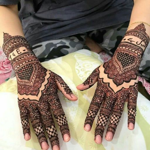 a woman's hands with henna tattoos on them (6)