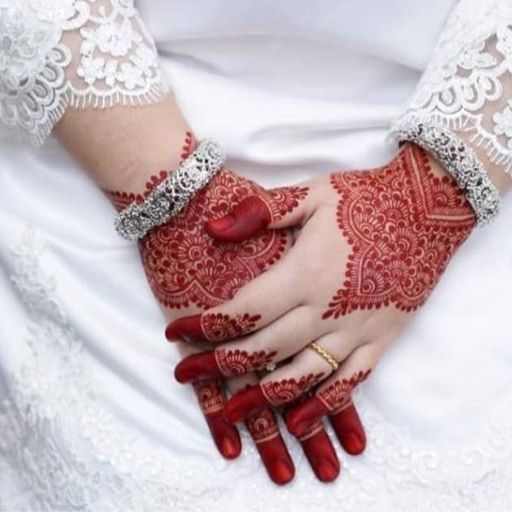 a woman's hands with hennap and bracelets