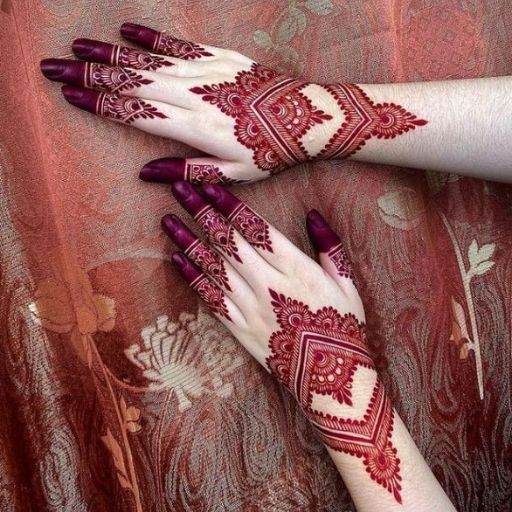 two hands with henna designs on them