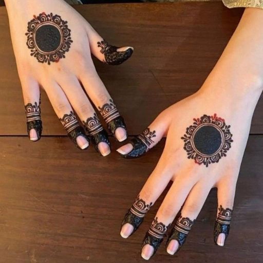 two hands with henna tattoos on them