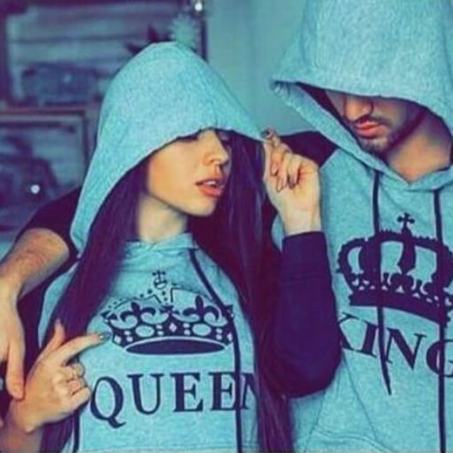 A couple in matching hoodies, one labeled _Queen_ and the other _King,_ showcasing their affectionate bond