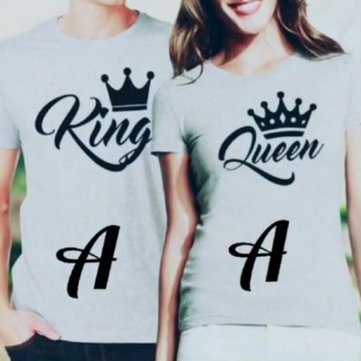 A couple proudly wearing matching king and queen shirts, showcasing their royal-themed attire and affection for each other