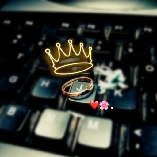 A drawn crown hovers above a 'J' key on a blurred keyboard, with a heart, two flowers, and a quotation mark nearby