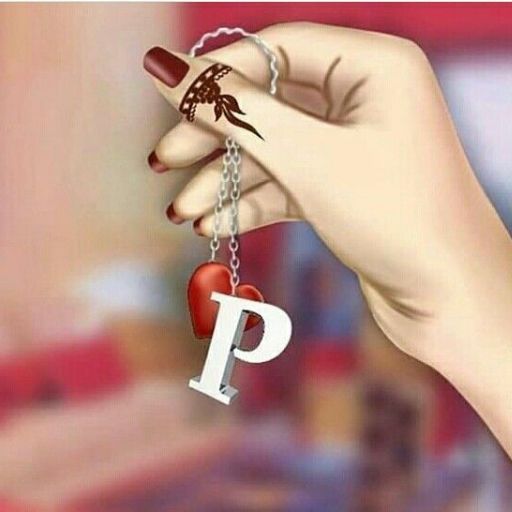 A hand with brown nail polish and a henna tattoo holding a keychain with letter _P_ and a small red heart