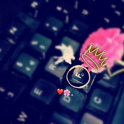 A ring and doodled crown on a computer keyboard's _Enter_ key with decorative emojis