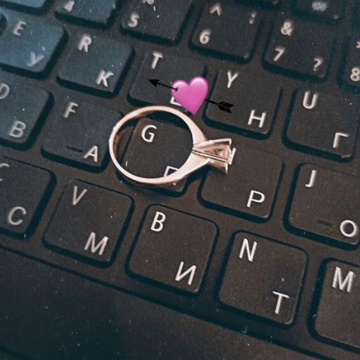 A ring on a keyboard with a graphic heart and arrow overlay