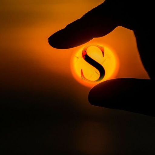 A silhouette of a hand pinching a sunset with a superimposed _S_ symbol, creating an illusion