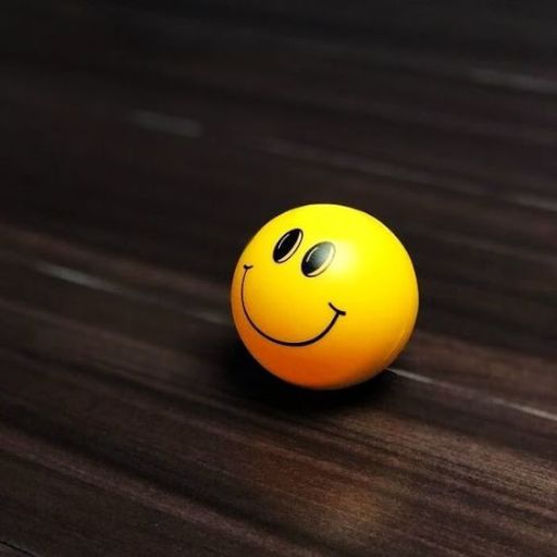 A yellow smiley face ball on a dark wooden surface