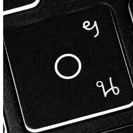 Close-up of a black and white keyboard key with the letter 'O' on it