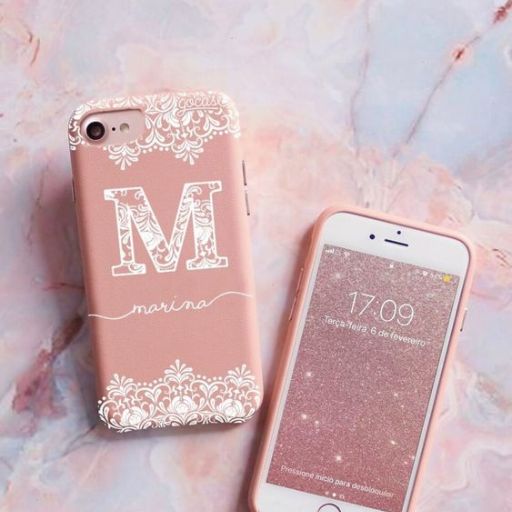 Customized pink phone case with initial M and name Marina beside an iPhone displaying the time