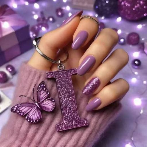 Hand with purple manicured nails holding a glittery purple 'I' pendant, with a butterfly and lights in the background