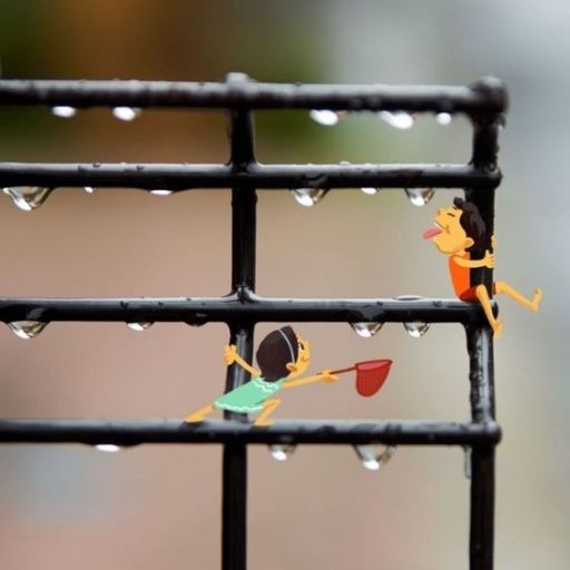 Illustration of two miniature figures climbing a wet fence with water droplets hanging off the bars