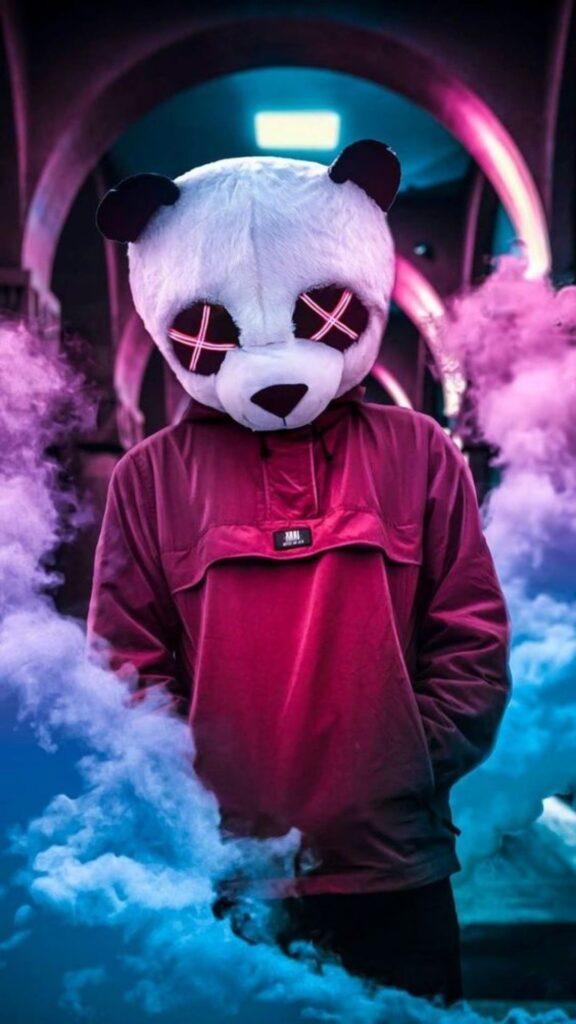 Person in panda mask standing amidst colored smoke with neon lights