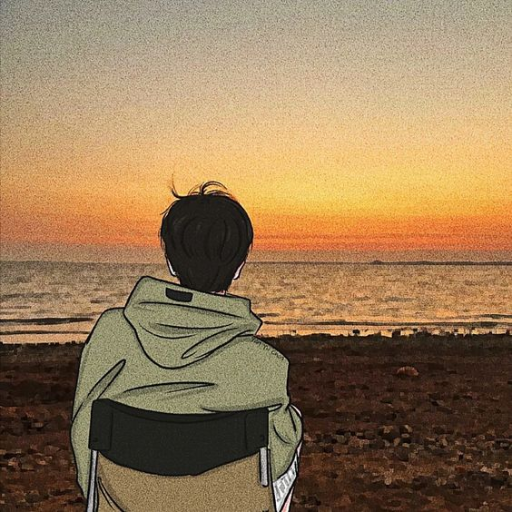 Person watching a sunset by the sea, with autumn hues in the sky