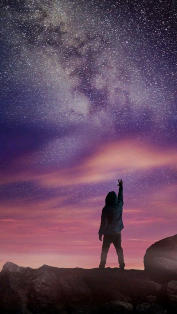 Silhouetted person reaching up to a starry night sky with purple hues